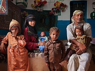 Photo by Stephanie Sinclair @stephsinclairpix @tooyoungtowed // A young wife with her husband and four children in Yemen. The World Health Organization reports an estimated 16 million adolescents between 15 and 19 – and another 1 million under the age of 15 – give birth each year. The younger the bride is when married, the less say she will have in family planning and the more likely it is that she will have complications during delivery. This image is part of a 175-image exhibition titled “Too Young to Wed,” which is the inaugural exhibition at the new L’Arche du Photojournalisme, atop at the prestigious Grand Arche de la Défense in Puteaux, Paris. Many of the images were made #onassignment for @natgeo, including this one. The show, which opened June 1 and runs through this Sunday, Sept. 24, is complete with educational information about the dangers of #childmarriage and the efforts underway around the world to end the global practice – including our work at our nonprofit organization of the same name, @TooYoungToWed. To learn more about the exhibition please visit the link to my blog in my bio @stephsinclairpix . #endchildmarriage #tooyoungtowed #girls #letgirlslearn #photojournalism #exhibition  #yemen #paris